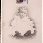 Young Child with picture of two ladies tucked into album on 